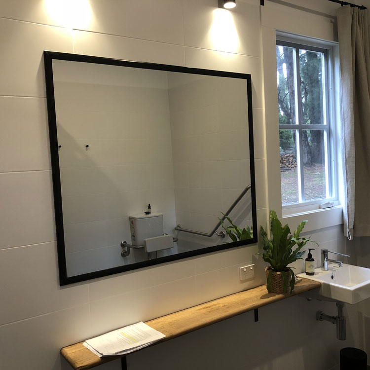 Custom cut mirror with black perimeter frame in Flinders